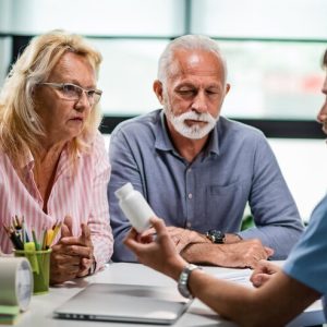 senior-couple-discussing-with-doctor-about-prescription-medicine-consultations_637285-1475